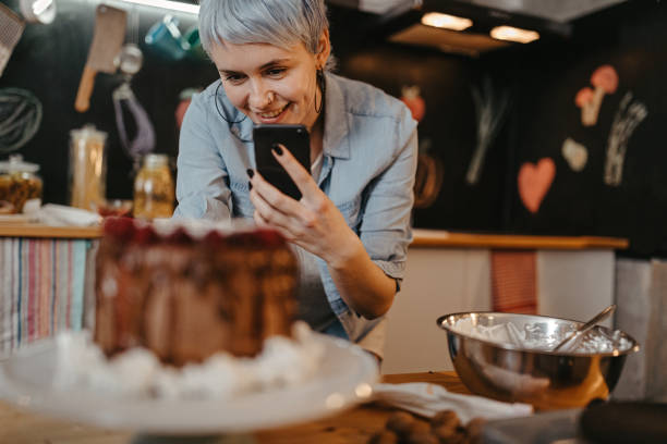 istock Woman photographing cake at domestic kitchen 1222451277