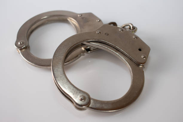 istock steel metal Handcuffs on  white background isolate 1222451290