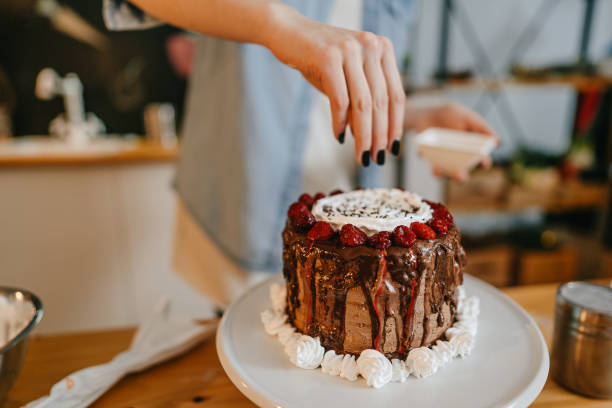 istock Woman decorating homemade cake 1222452080