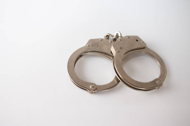 istock steel metal Handcuffs on  white background isolate 1222452662