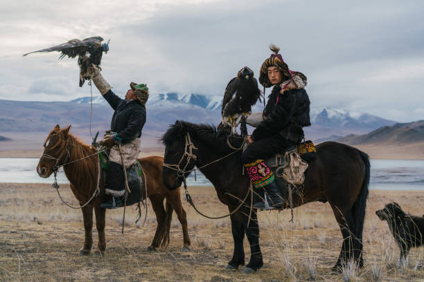 istock Eagle hunters on horses near the river in Mongolia 1222453025