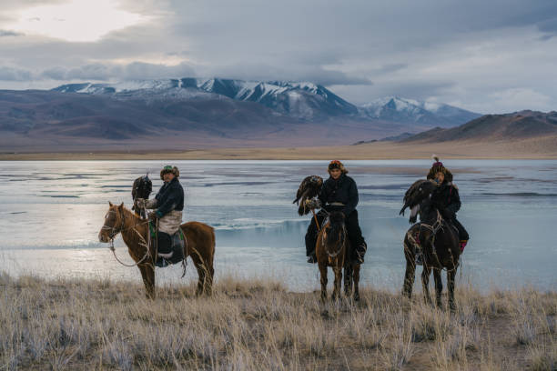 istock Eagle hunters on horses near the river in Mongolia 1222453063