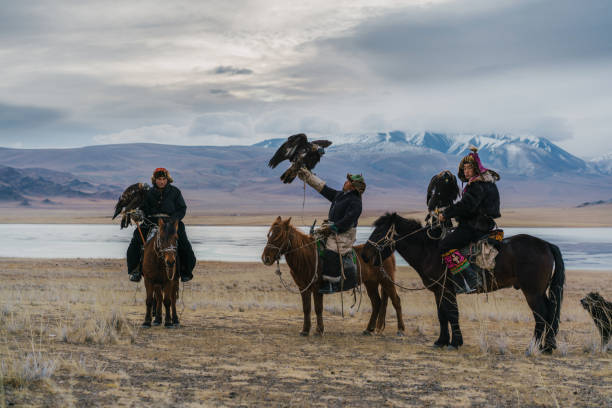 istock Eagle hunters on horses near the river in Mongolia 1222453069