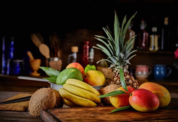istock Group of ripe tropical fruits on a table in a rustic kitchen 1222453624