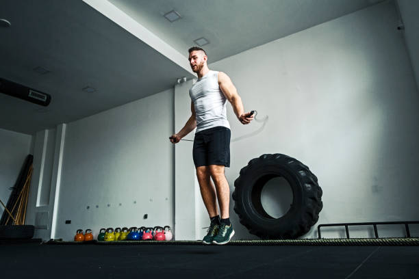 Young man training with his jump rope in the gym young man training with jump rope in the gym training skipping stock pictures, royalty-free photos & images