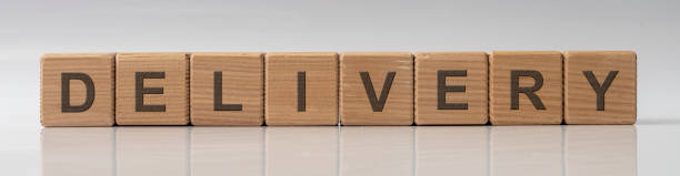 istock concept word DELIVERY on cubes on a white grey glossy background with reflection 1222455192