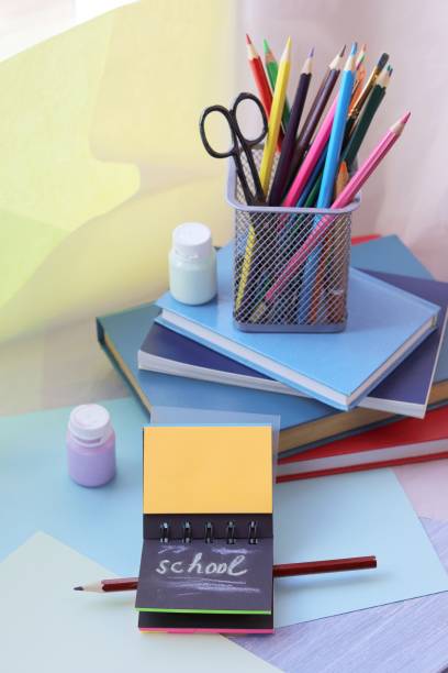 istock School stationery, books on the table, home schooling concept 1222456157