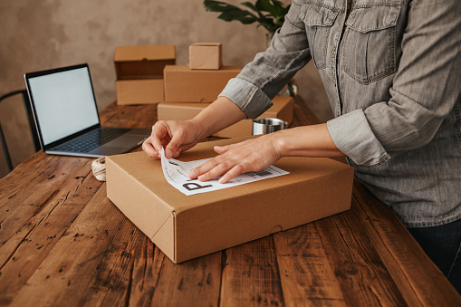 Female entrepreneur preparing the shipment for delivery.