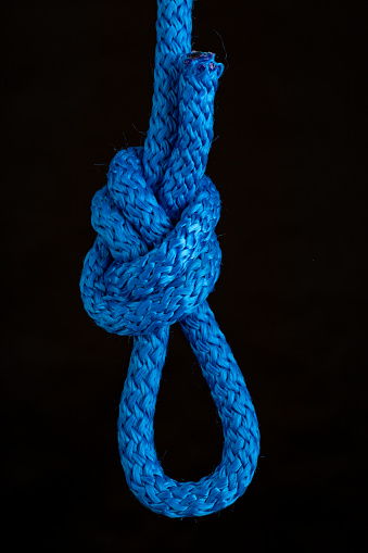 Nautical knot loop. Weave a thick rope. Dark background.