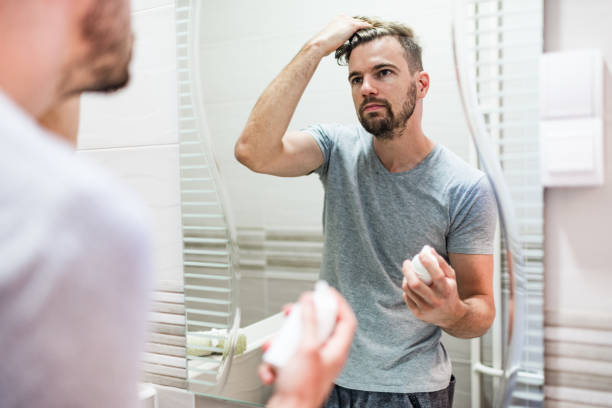 istock Young man stylizing his hair in the bathroom 1222457653