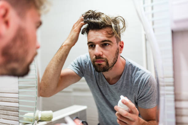 istock Young man stylizing his hair in the bathroom 1222457873