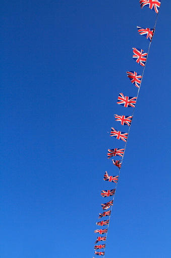 Clear blue sky with flags flying in the breeze.