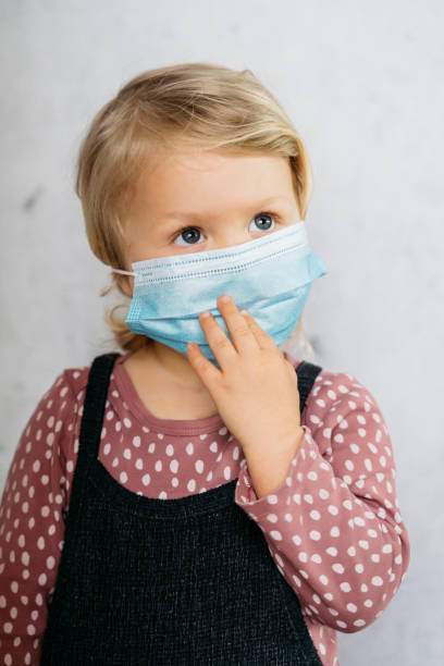 istock Little girl wearing mouth protection 1222461249