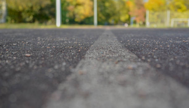 istock Jogging path at the school stadium leading to the park close-up 1222464451