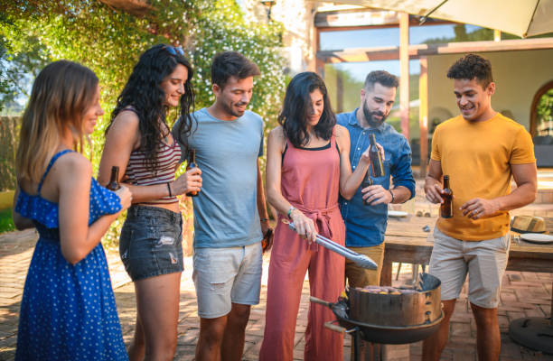 istock Friends Looking Forward to Salad and Barbecue at Party 1222464592