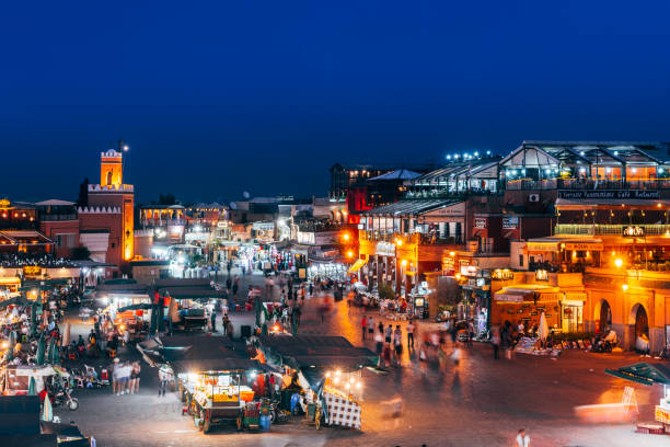 crowded square of djemaa el fna in marrakech, morocco MARRAKECH, MOROCCO. 30th September, 2017: panoramic views of djemaa el fna square in marrakech were street vendors sell their food at stalls, morocco djemma el fna square stock pictures, royalty-free photos & images