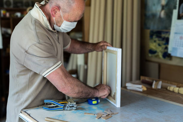 istock Craft men 60-65 years, with protective mask working in isolation in his workshop, head shot - stock photo 1222467804