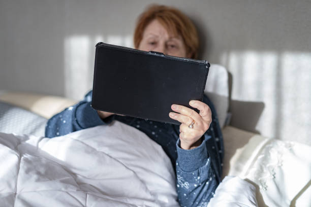 istock Mature woman 65-70 years lying in bed in isolation 1222467836