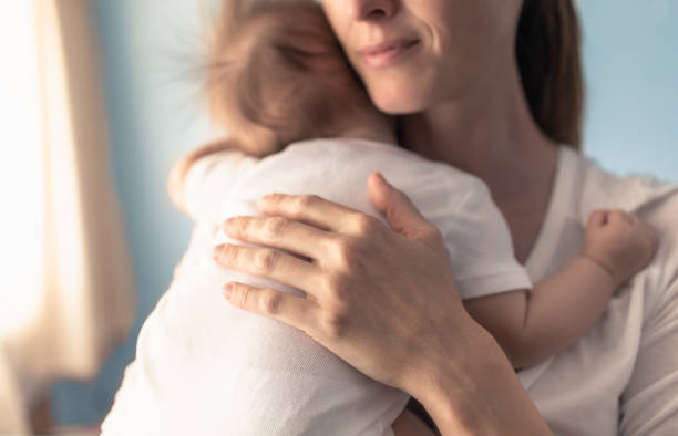 istock Mother putting her baby to sleep. 1222467979