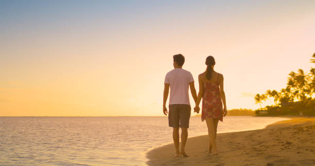 istock Couple walking on the beach 1222468906