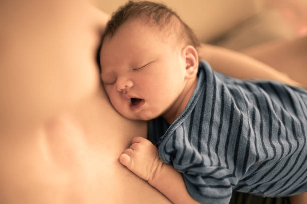 istock Cute newborn baby sleeping in mothers arms. 1222468962