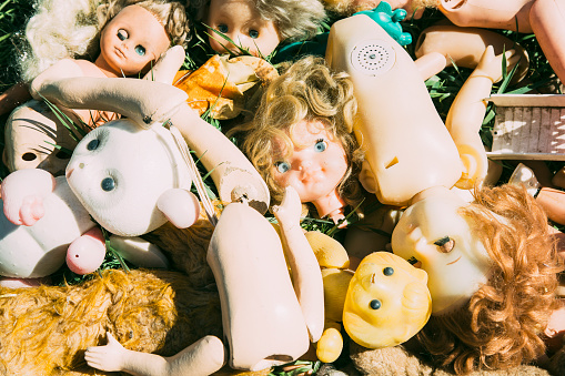 Many old broken dolls and toys