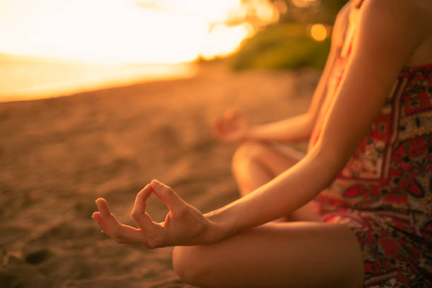 istock Woman meditating on the beach 1222469035