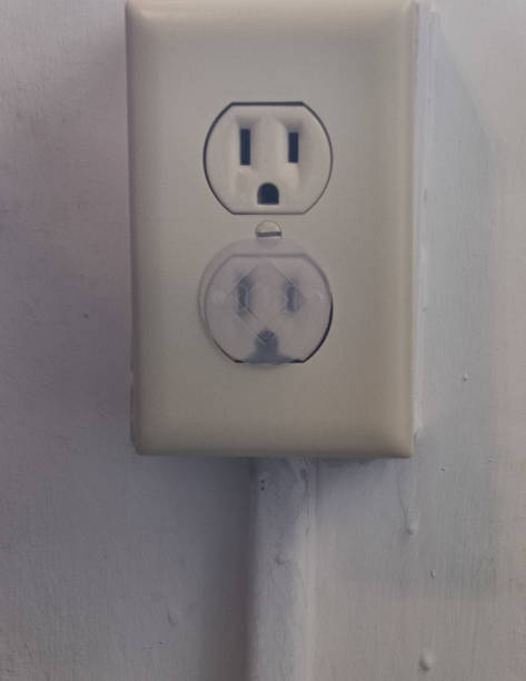 istock Close up of an electrical outlet with a child safety plug 1222470080