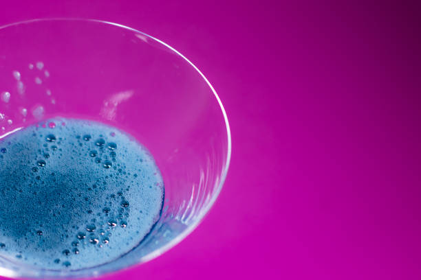Blue martini glass on white table.