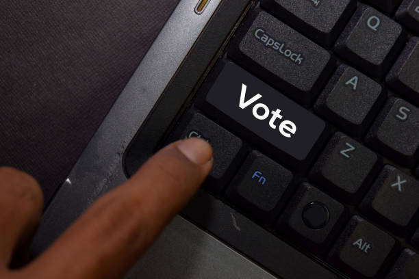 istock Vote isolated on laptop keyboard background 1222471557