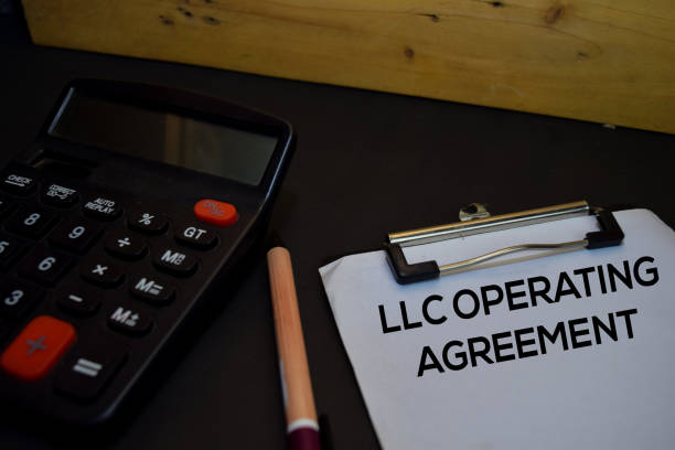 istock LLC Operating Agreement write on a paperwork isolated on wooden background. 1222471721