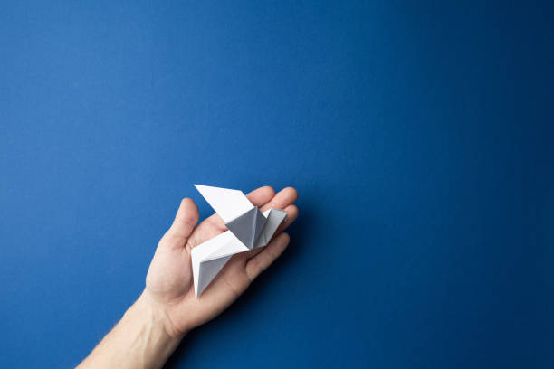 istock Paper pigeon on a blue isolated background. 1222472562