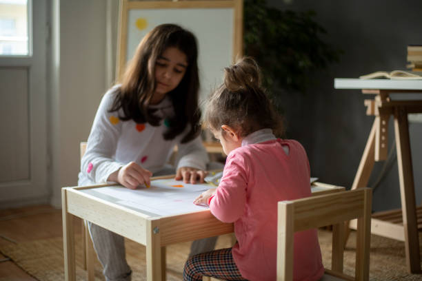 istock Sisters Are Drawing Pictures Together 1222476002