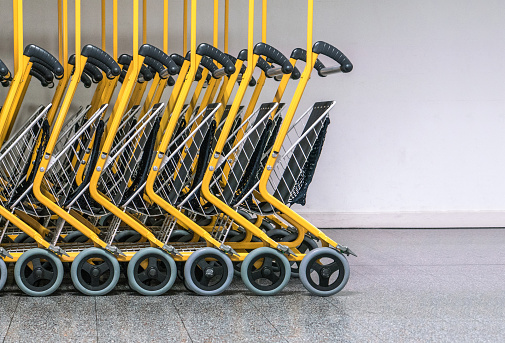 Row of chrome shopping carts at a supermarket