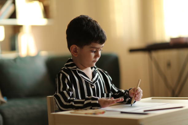 istock Adorable little boy, drawing picture 1222478309