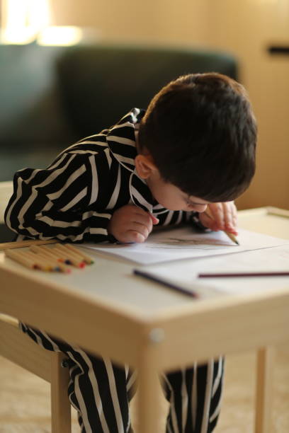 istock Adorable little boy, drawing picture 1222478319