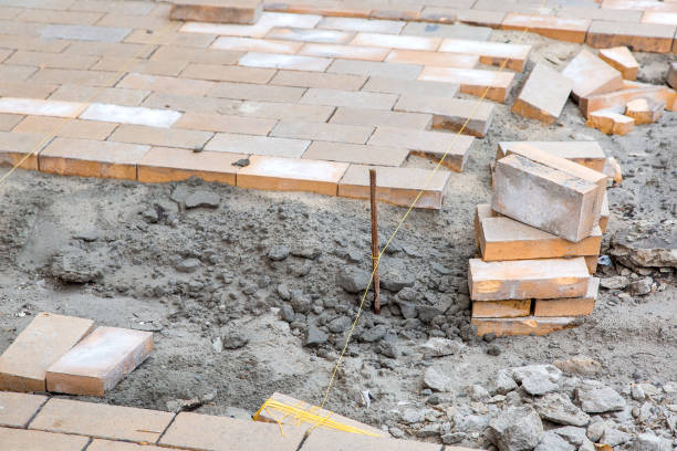 istock paving of a new sidewalk from rectangular stone tiles according to the marks of the stretched thread of the level, a close-up of the repair work of the stone path. 1222479171