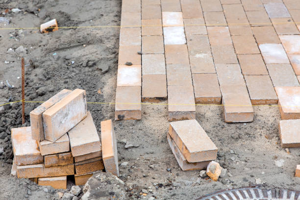 istock paving of a new sidewalk from rectangular stone tiles according to the marks of the stretched thread of the level, a close-up of the repair work of the stone path. 1222479177