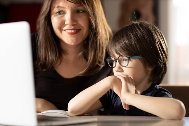 istock Mother and Boy with Laptop 1222481118