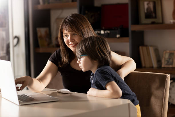 istock Mother and Boy with Laptop 1222481119