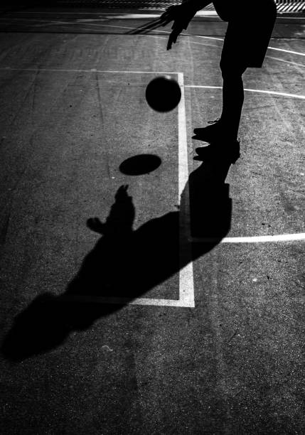 istock Man doing a free throw in a basketball game. B&W. Copy space. 1222482844