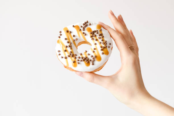 Female hand holding delicious donut