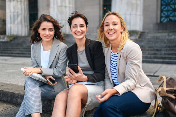 istock Young Female Law Students Relaxing Outdoors with Smart Phone 1222487200