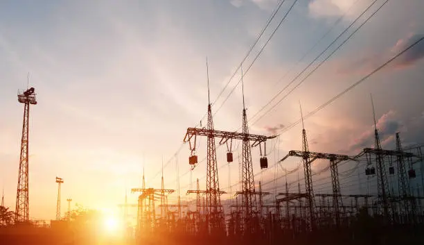 High-voltage power lines. Distribution electric substation with power lines and transformers.