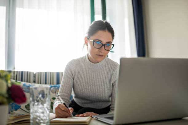 Young Woman Doing Finances at Home stock photo