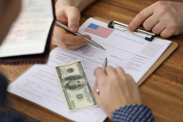 istock Dollars and passport are visa application form usa 1222488015