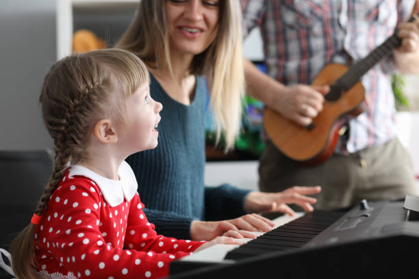 istock Parents teach daughter to play musical instruments 1222488024