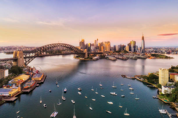 D SY Lavender mid bay rise Sunrise in Sydney city - aerial view from Lavender bay to the Sydney harbour bridge and CBD skyline. sydney harbor photos stock pictures, royalty-free photos & images