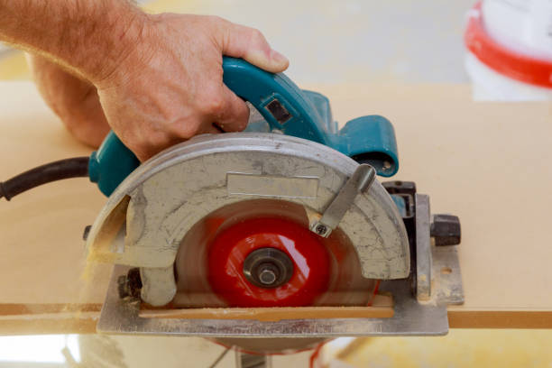 istock Carpenters hands cutting wood with electric saw 1222492576