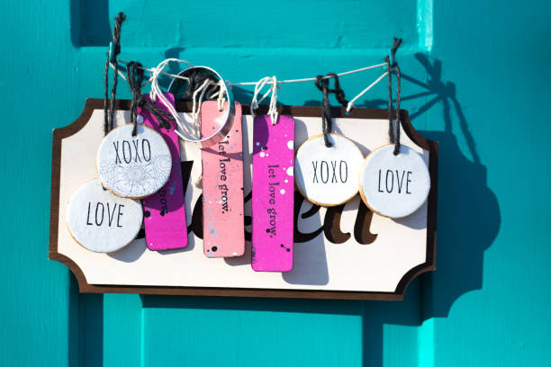 Santa Fe, NM: A turquoise door with a closed sign and colorful tags with positive  messages on historic Canyon Road in downtown Santa Fe, NM during the COVID pandemic.